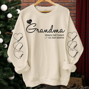 Grandma Wears Her Heart On Her Sleeve - Family Personalized Custom Unisex Sweatshirt With Design On Sleeve - Christmas Gift For Mom, Grandma