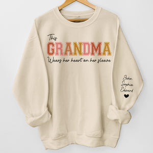 Grandma's Heart Belongs To - Family Personalized Custom Unisex Sweatshirt With Design On Sleeve - Gift For Grandma, Mom