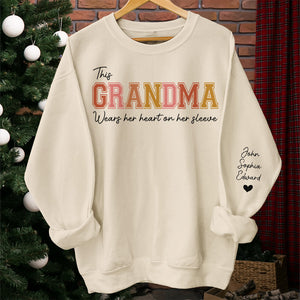 Grandma's Heart Belongs To - Family Personalized Custom Unisex Sweatshirt With Design On Sleeve - Gift For Grandma, Mom