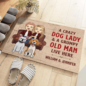 A Crazy Dog Lady And Her Grumpy Old Man Live Here - Personalized Decorative Mat.